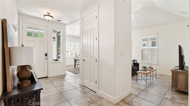 foyer entrance featuring ceiling fan