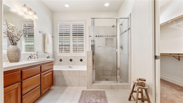 bathroom featuring tile patterned floors, vanity, and independent shower and bath