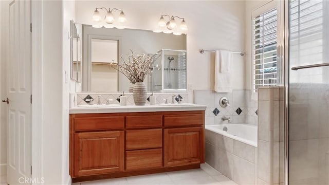 bathroom featuring tile patterned floors, vanity, and shower with separate bathtub