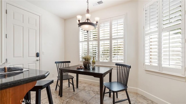 dining space featuring an inviting chandelier