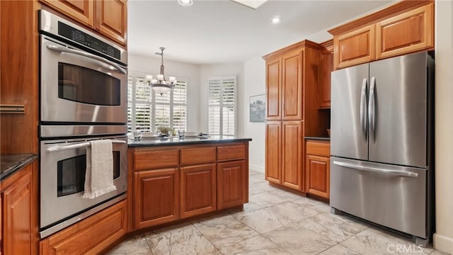 kitchen featuring hanging light fixtures, a chandelier, and appliances with stainless steel finishes