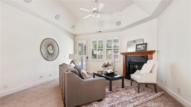 interior space with light carpet, a high end fireplace, and ceiling fan