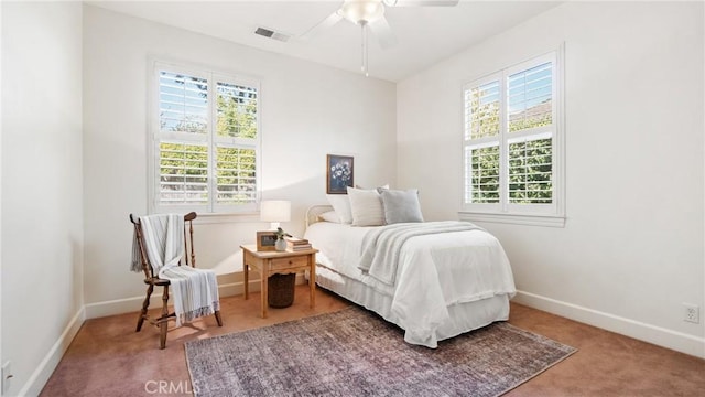 bedroom featuring ceiling fan, carpet floors, and multiple windows