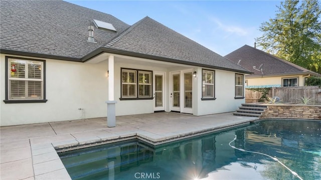 rear view of house featuring a patio area and a pool with hot tub