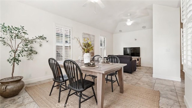 dining area featuring ceiling fan and lofted ceiling