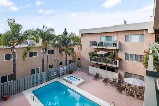 view of pool featuring a community hot tub and a patio area