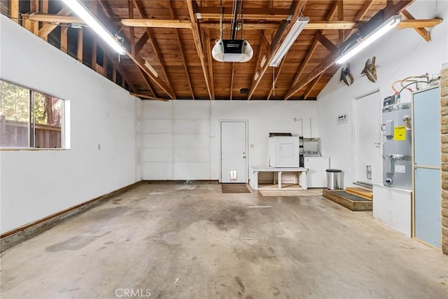 garage featuring washer / dryer, baseboards, and a garage door opener