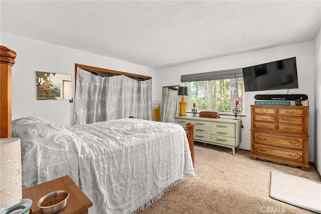 bedroom with light colored carpet and a textured ceiling