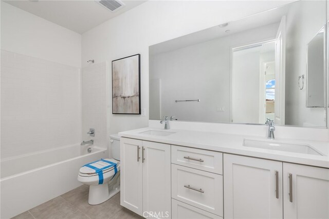 full bathroom with tile patterned floors, shower / washtub combination, vanity, and toilet