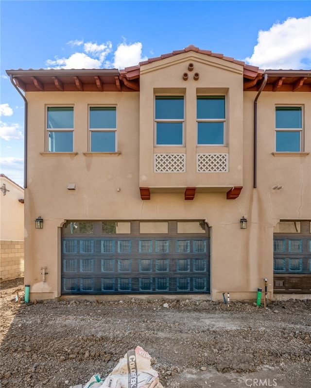 rear view of property featuring a garage