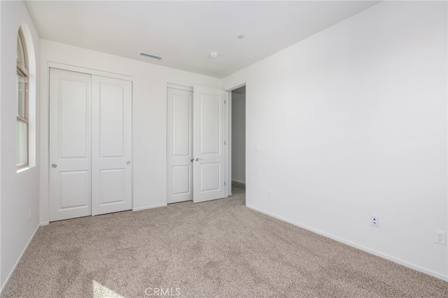 unfurnished bedroom with light carpet