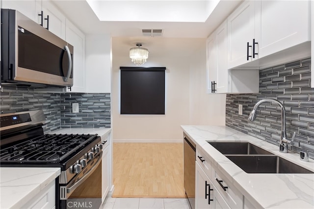 kitchen featuring white cabinets, appliances with stainless steel finishes, and sink