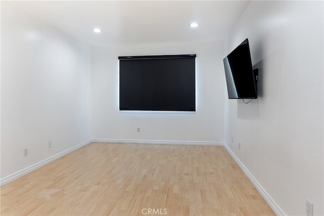 empty room with light hardwood / wood-style flooring