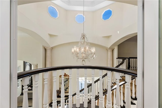 staircase featuring a notable chandelier