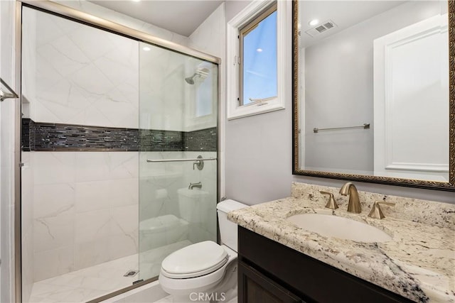 bathroom with toilet, an enclosed shower, and vanity