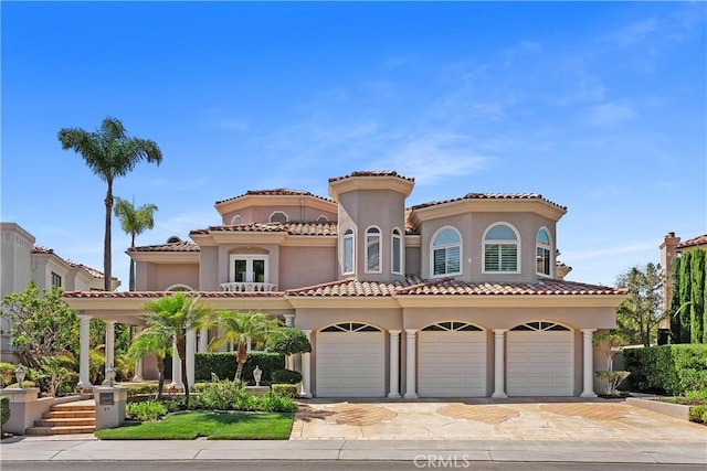 mediterranean / spanish-style house with a garage