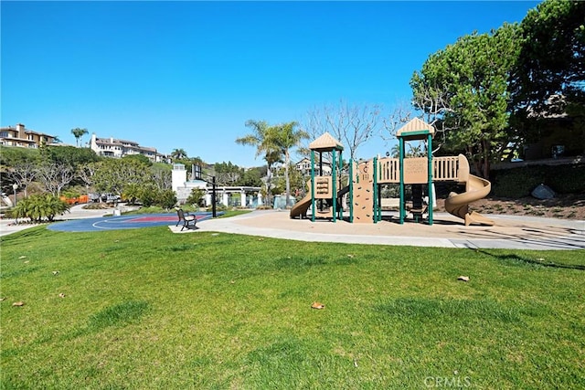 view of jungle gym featuring a yard and basketball hoop