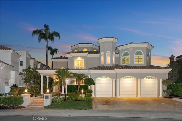 mediterranean / spanish-style house with a garage