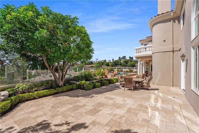 view of patio featuring a balcony