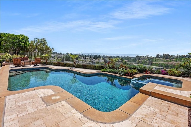 view of pool with a patio area and an in ground hot tub