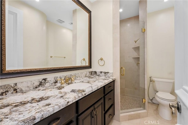 bathroom with toilet, vanity, tile patterned flooring, and an enclosed shower