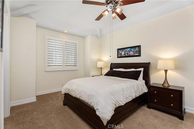 carpeted bedroom with ceiling fan and beamed ceiling