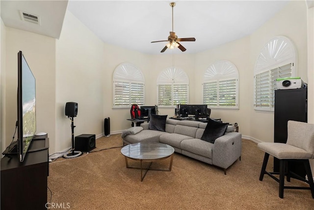 carpeted living room featuring ceiling fan