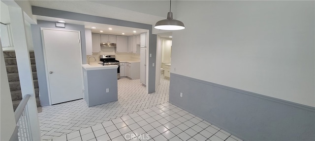 kitchen with stainless steel stove, light tile patterned flooring, hanging light fixtures, and sink