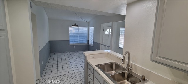 bathroom featuring tile patterned flooring, a textured ceiling, and sink