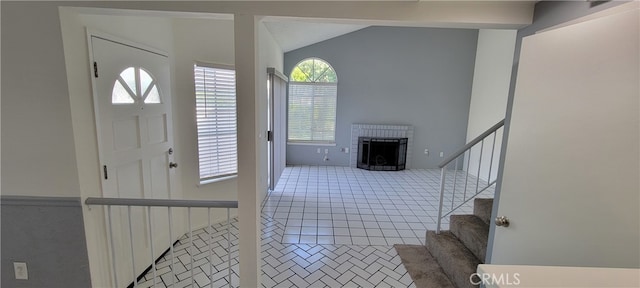 tiled foyer with lofted ceiling