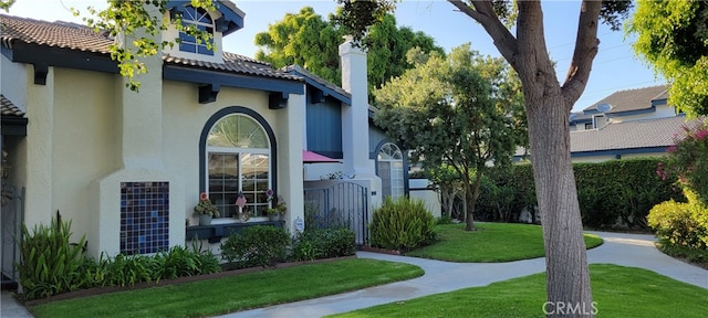 property entrance featuring a lawn