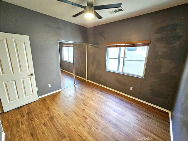 unfurnished bedroom with light wood-type flooring and ceiling fan