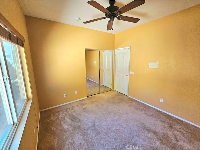 unfurnished bedroom featuring carpet and ceiling fan