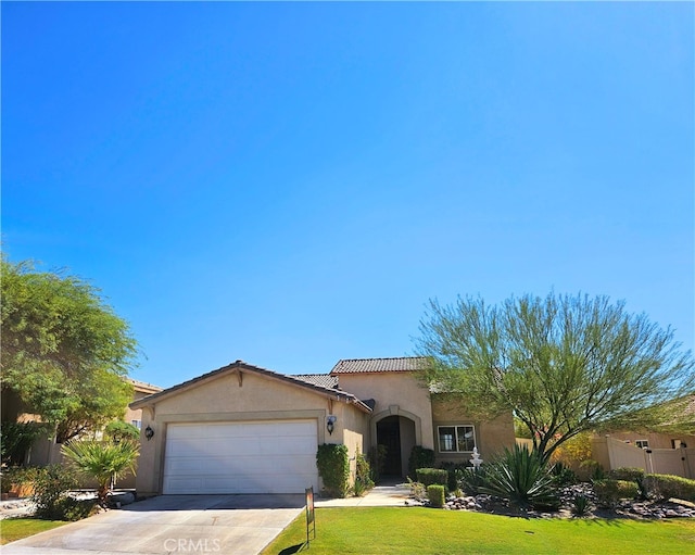 view of front of house with a garage and a front lawn