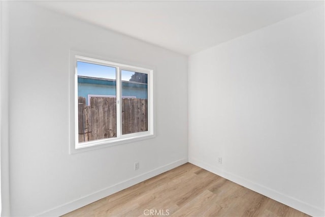 unfurnished room with light wood-type flooring