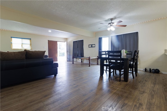 dining area featuring ceiling fan, a textured ceiling, and dark hardwood / wood-style floors