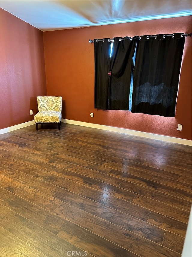 unfurnished room featuring dark wood-type flooring