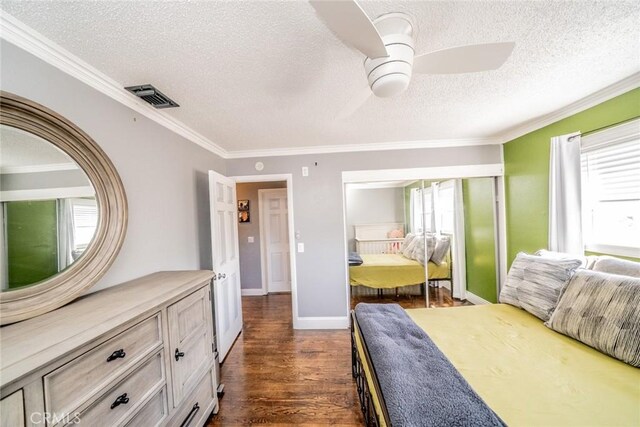 bedroom with ceiling fan, dark hardwood / wood-style flooring, crown molding, and a textured ceiling