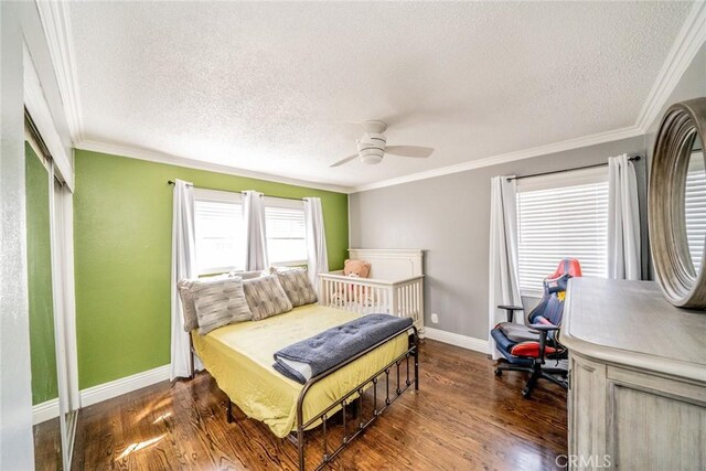 bedroom featuring a textured ceiling, dark hardwood / wood-style flooring, ceiling fan, and ornamental molding