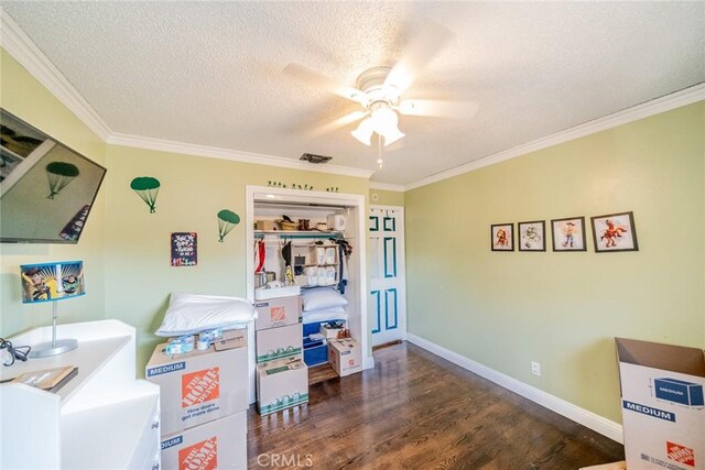 interior space featuring a textured ceiling, dark hardwood / wood-style flooring, ceiling fan, and ornamental molding