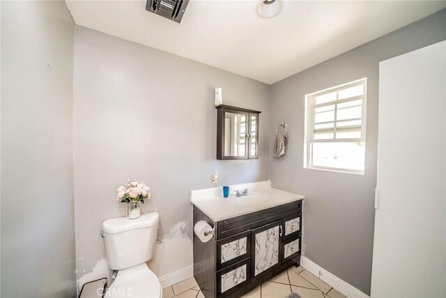 bathroom featuring tile patterned floors, vanity, and toilet