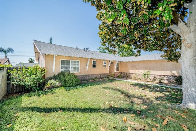 rear view of property featuring a yard