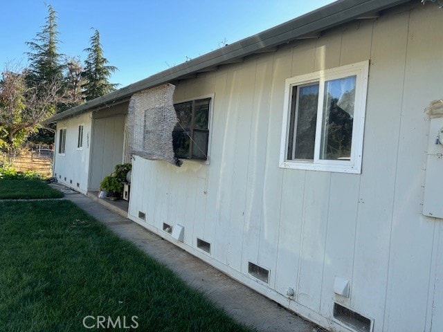 view of side of property with a lawn