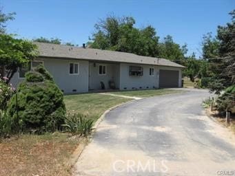 ranch-style house with a front yard and a garage