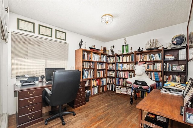 office featuring hardwood / wood-style flooring and a textured ceiling