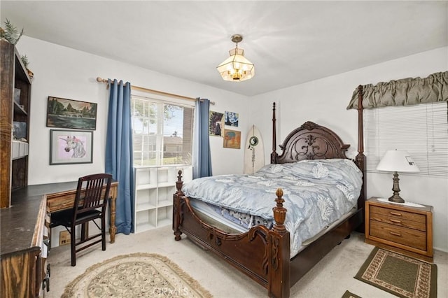 carpeted bedroom with a notable chandelier