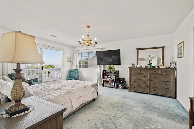 carpeted bedroom featuring a chandelier