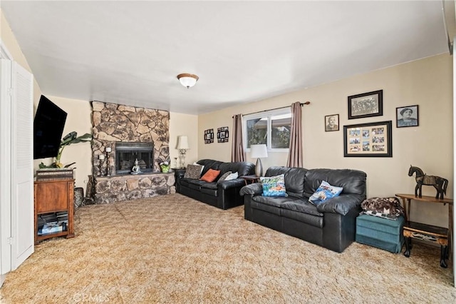 living room featuring a stone fireplace and carpet