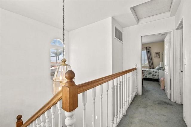 hall featuring light colored carpet