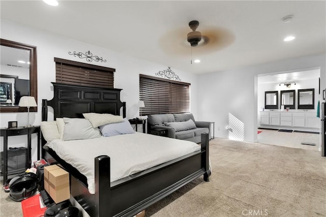 bedroom with ensuite bath, ceiling fan, and carpet